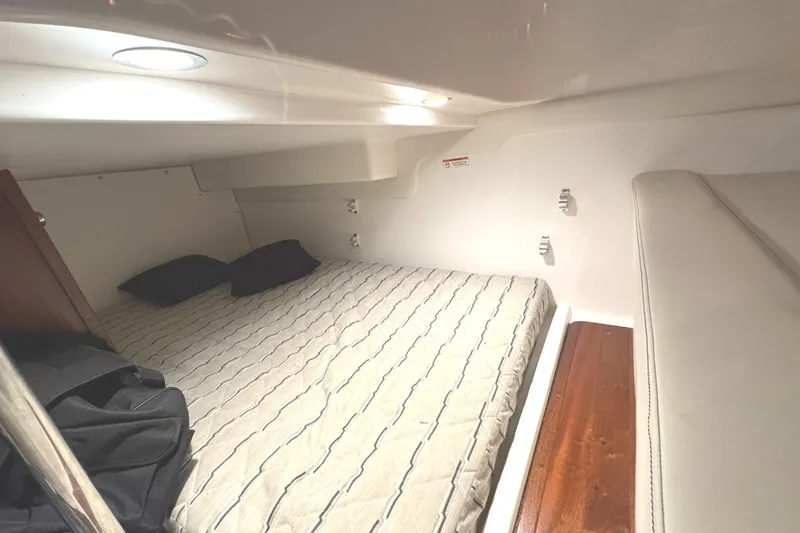 Slide: The Image of 2019 Pursuit OS 385 Offshore cabin interior with bed and cushions. - 15