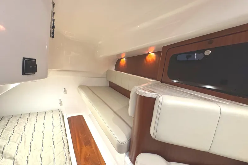 Slide: The Image of 2019 Pursuit OS 385 Offshore cabin interior with elegant seating and ambient lighting. - 16