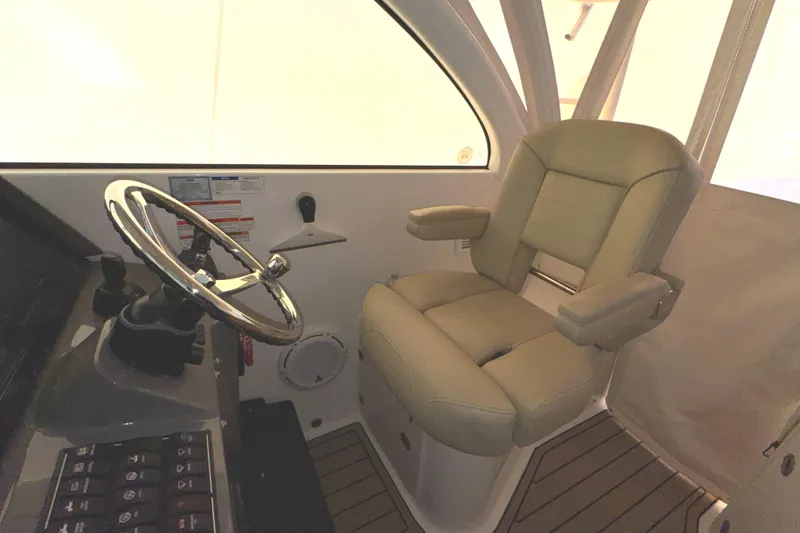 Slide: The Image of 2019 Pursuit OS 385 Offshore helm with steering wheel and captain's chair. - 28