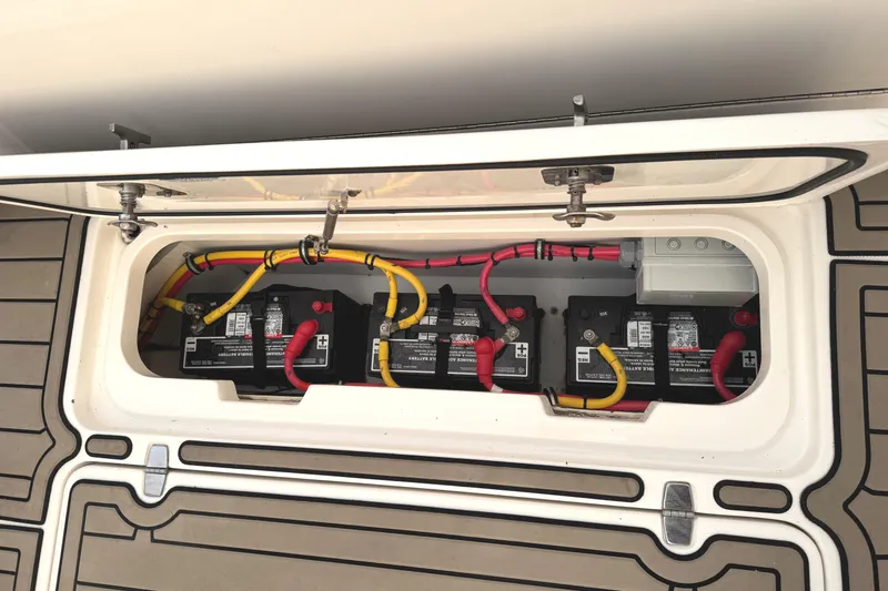 Slide: The Image of 2019 Pursuit OS 385 Offshore boat battery compartment with multiple batteries and wiring. - 36