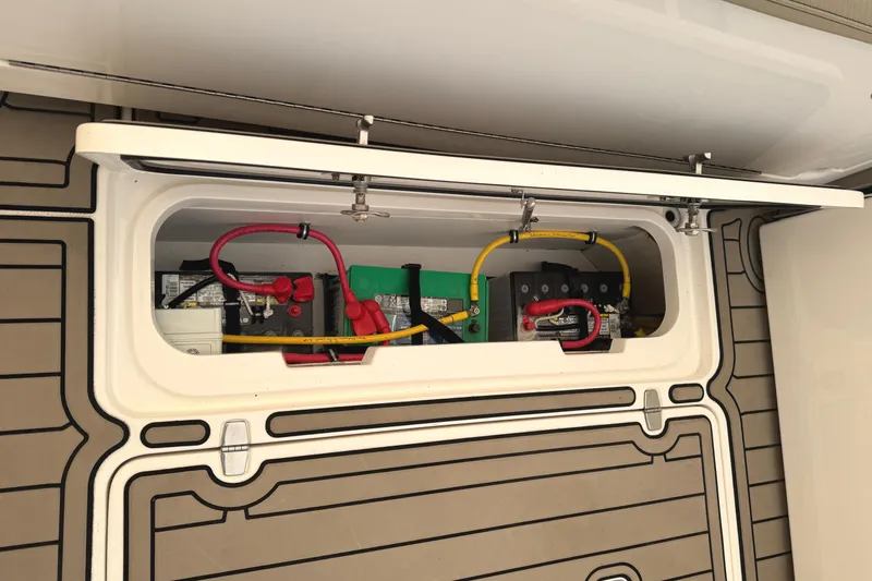 Slide: The Image of 2019 Pursuit OS 385 Offshore boat battery compartment with wiring and connections. - 37