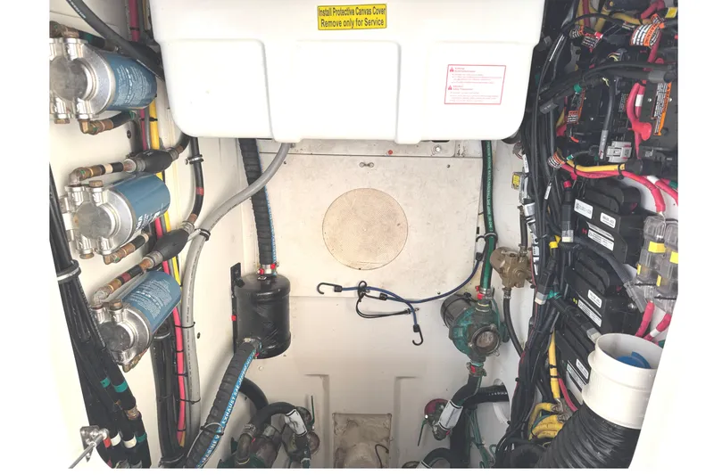 Slide: The Image of 2019 Pursuit OS 385 Offshore engine compartment with wiring and components. - 39