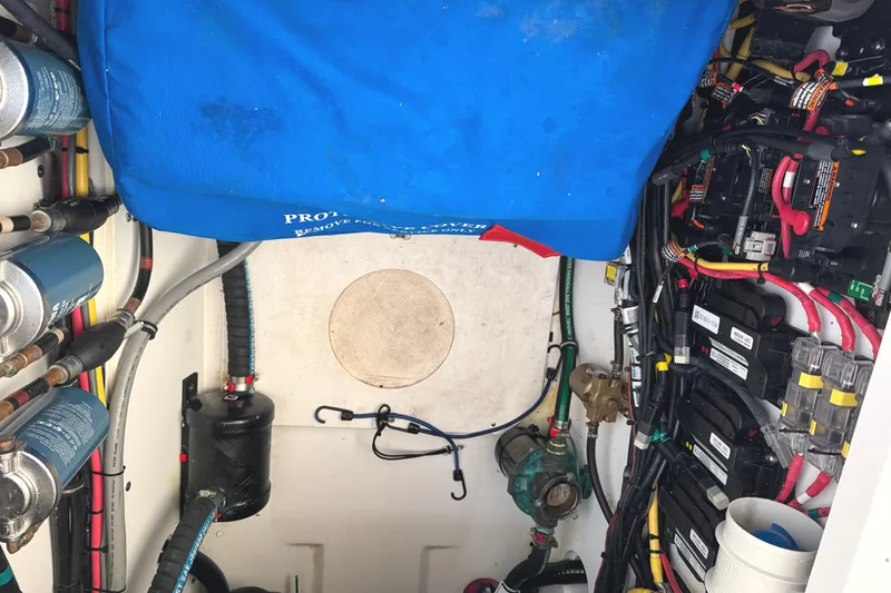 Slide: The Image of Engine compartment of 2019 Pursuit OS 385 Offshore boat, showcasing wiring and components. - 40
