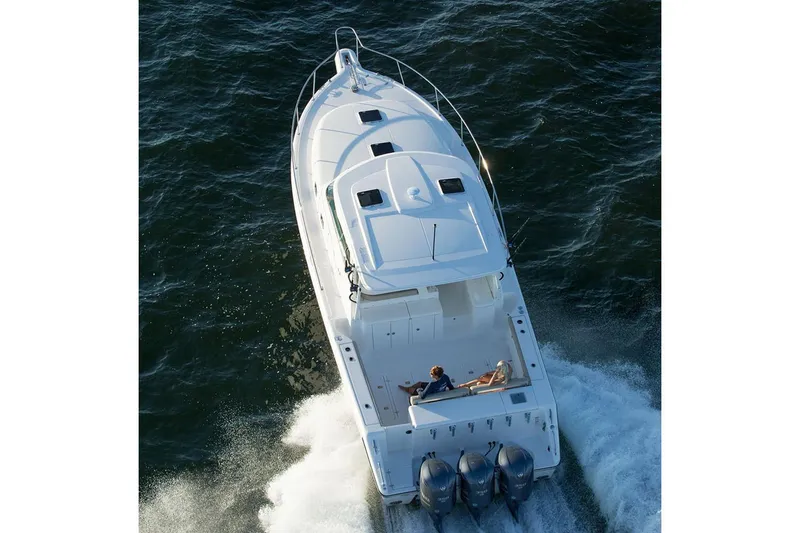 Slide: The Image of Manufacturer Provided Image: 2019 Pursuit OS 385 Offshore boat cruising on water, aerial view. - 42