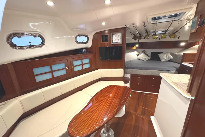 Slide: The Image of Luxurious 2019 Pursuit OS 385 Offshore cabin interior with elegant seating and fishing rod storage. - 6