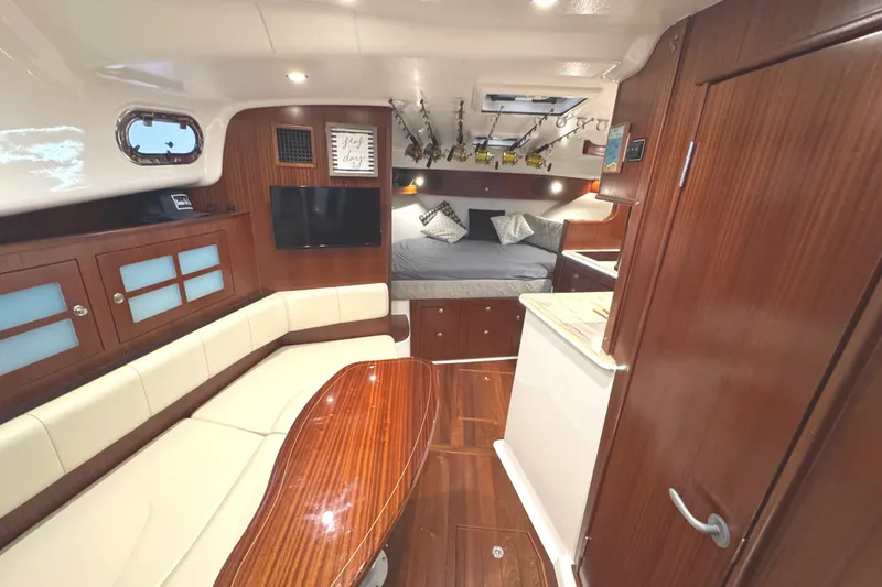 Slide: The Image of Luxurious 2019 Pursuit OS 385 Offshore yacht interior with elegant wood finishes and cozy seating. - 7