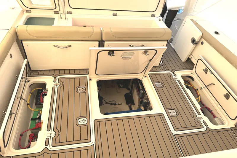 Slide: The Image of 2019 Pursuit OS 385 Offshore boat deck with open storage compartments and seating. - 8
