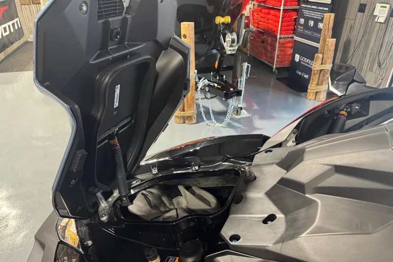 Slide: The Image of 2026 Kawasaki ULTRA 160LX-S jet ski with open storage compartment in showroom. - 11