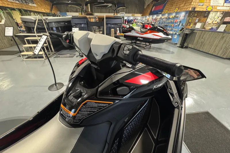 Slide: The Image of 2026 Kawasaki ULTRA 160LX-S jet ski in showroom, featuring sleek handlebars and modern design. - 7