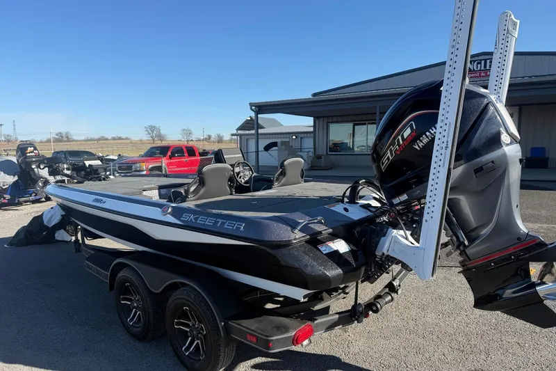 Slide: The Image of 2024 Skeeter ZXR19 boat with Yamaha engine, parked outdoors near a building. - 5