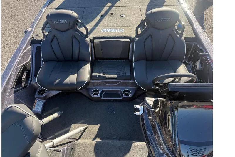 Slide: The Image of 2024 Skeeter ZXR19 boat interior with dual seats and steering wheel. - 9