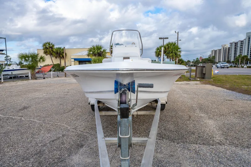 Slide: The Image of 2013 Tidewater 1900 Bay Max boat on trailer, parked outdoors under cloudy sky. - 12