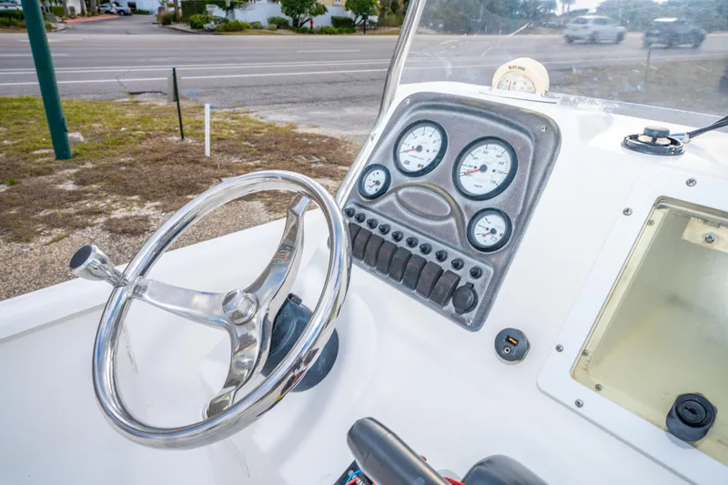 Slide: The Image of Steering console of a 2013 Tidewater 1900 Bay Max boat with gauges and controls. - 23