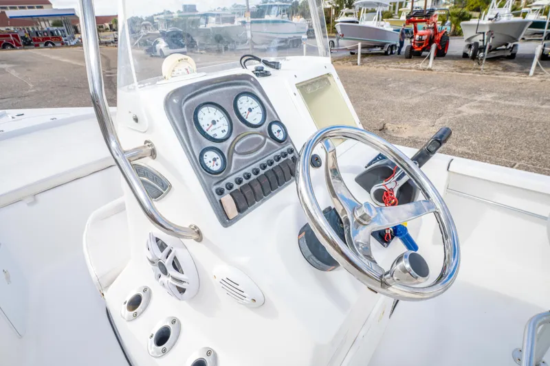 Slide: The Image of 2013 Tidewater 1900 Bay Max boat dashboard with steering wheel and gauges. - 26