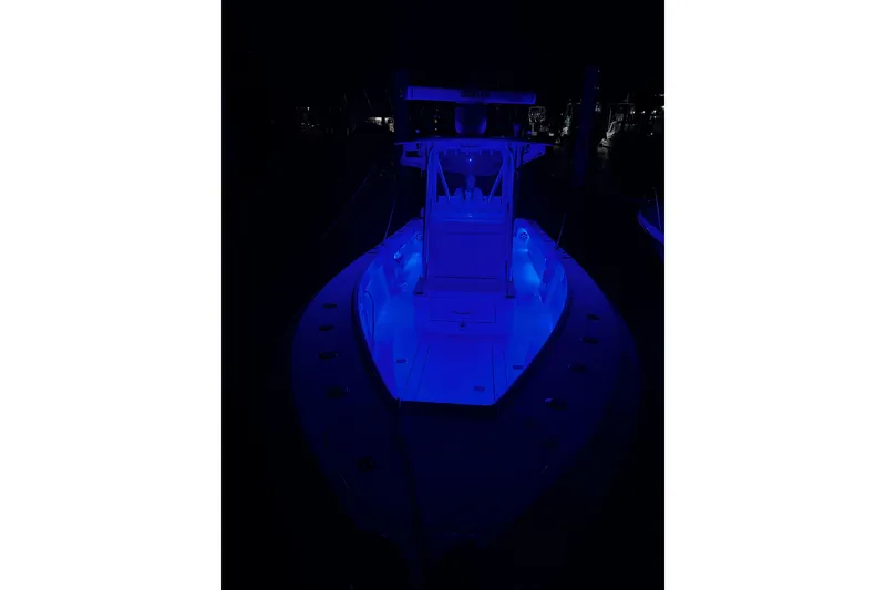 Slide: The Image of 2014 SeaVee 290B boat illuminated with blue lights at night. - 10