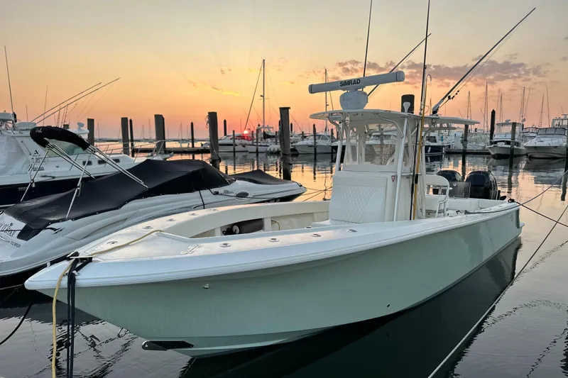 Slide: The Image of 2014 SeaVee 290B boat docked at sunset, surrounded by other vessels. - 6