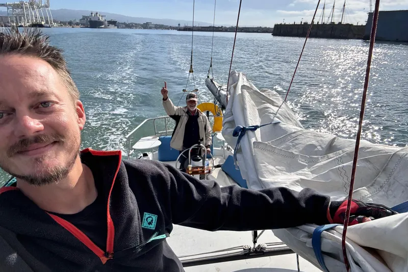 Slide: The Image of 1980 Catalina 30 sailboat docked at night with illuminated navigation lights. - 28