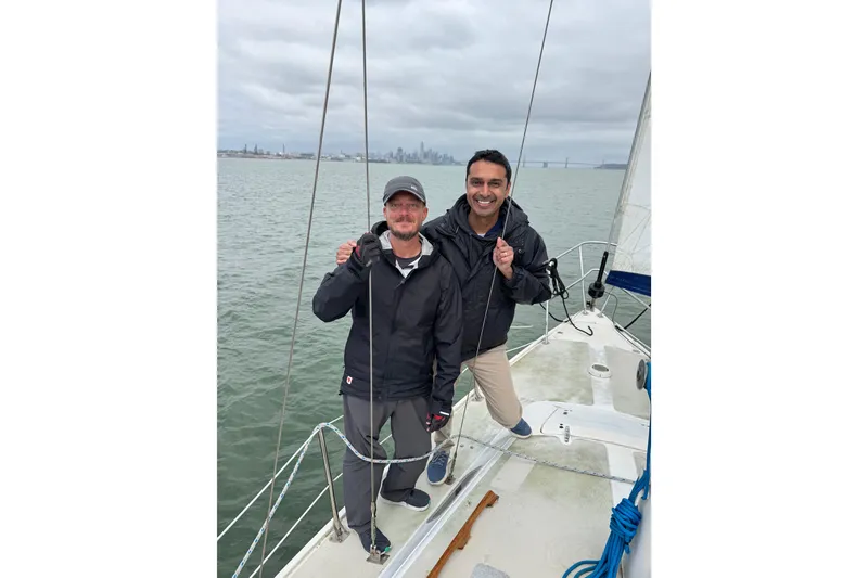 Slide: The Image of Group sailing on 1980 Catalina 30 yacht with city skyline and bridge in background. - 31