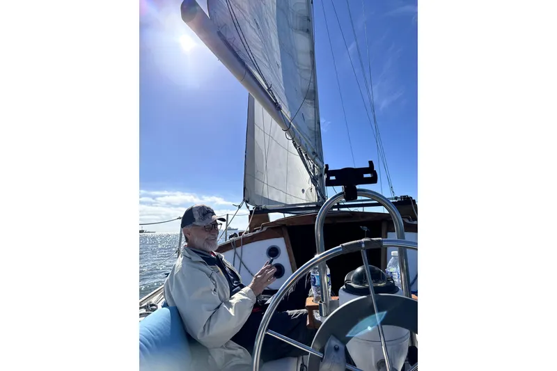 Slide: The Image of Man sailing a 1980 Catalina 30 yacht under clear blue skies. - 35