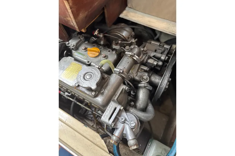 Slide: The Image of 1980 Catalina 30 sailboat docked in a marina under clear blue skies. - 5