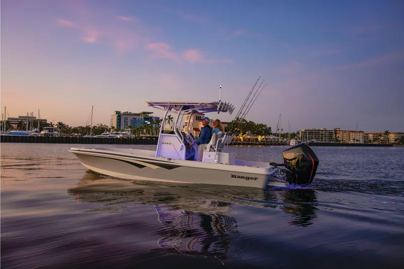 Slide: The Image of 2025 Ranger 2360 Bay boat with Mercury outboard engine, showcased indoors. - 2