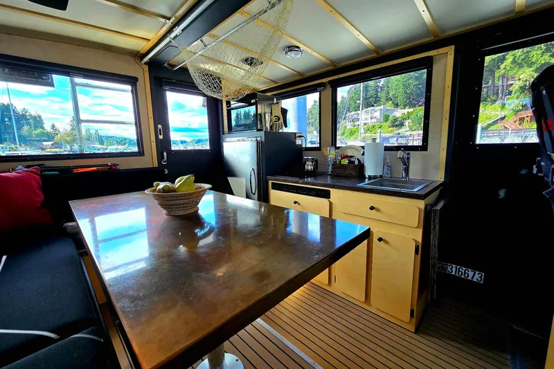 Slide: The Image of Interior of 2020 Armstrong Marine 35 boat with kitchen and dining area, scenic window views. - 105