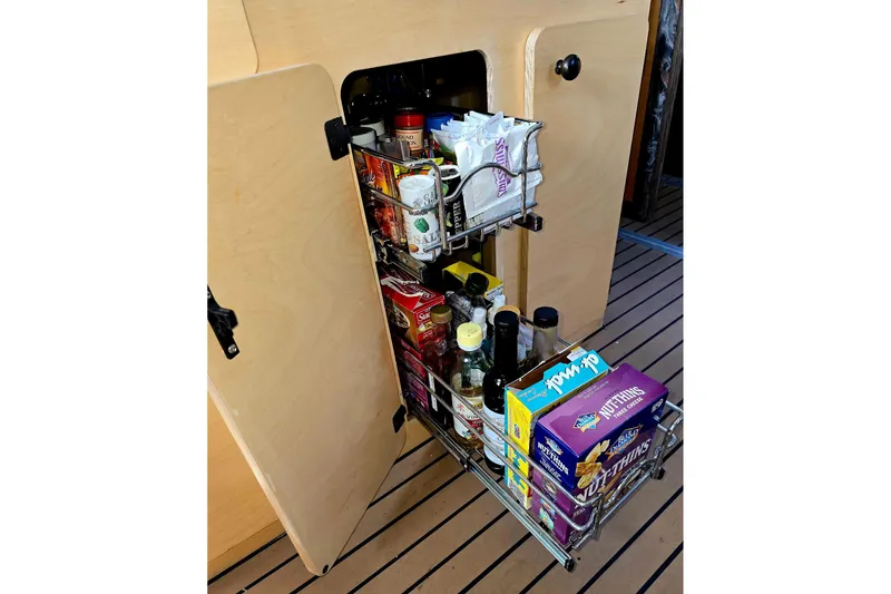 Slide: The Image of Pull-out pantry in 2020 Armstrong Marine 35 boat, stocked with various food items. - 106