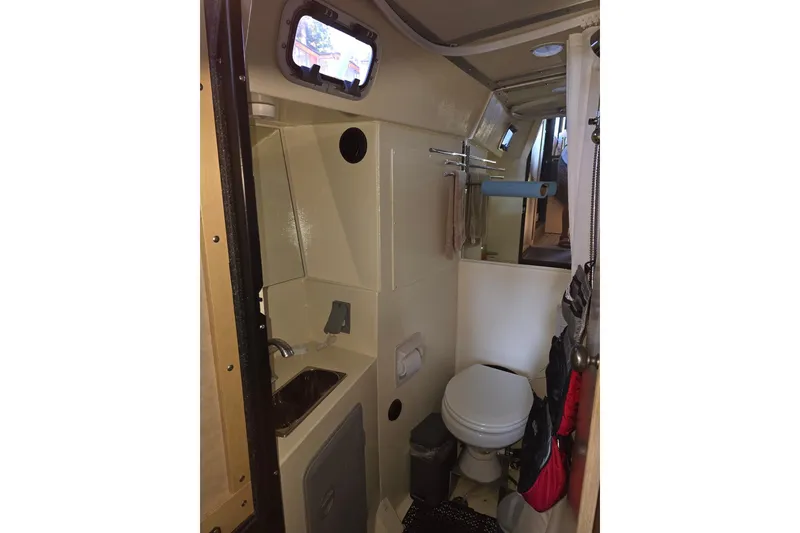Slide: The Image of Compact bathroom interior of 2020 Armstrong Marine 35 boat, featuring sink and toilet. - 110
