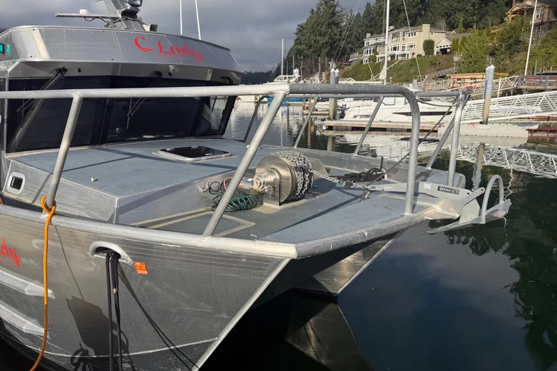 Slide: The Image of 2020 Armstrong Marine 35 boat docked by a lake under cloudy skies. - 4