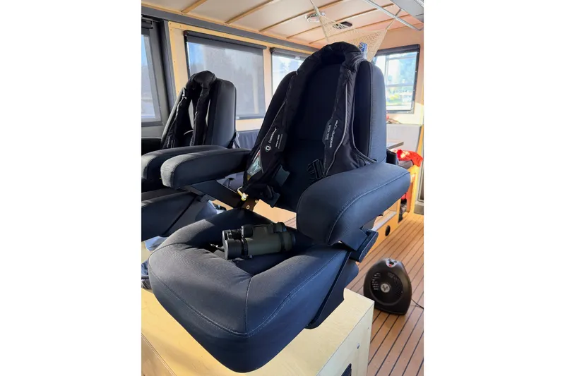 Slide: The Image of Storage area with jackets and a bag inside a 2020 Armstrong Marine 35 boat. - 55
