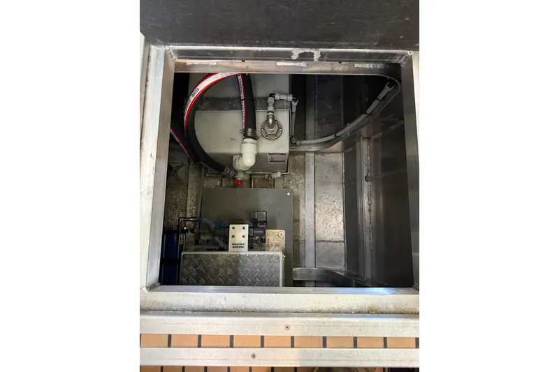 Slide: The Image of Interior storage compartment of a 2020 Armstrong Marine 35 boat with various items. - 65