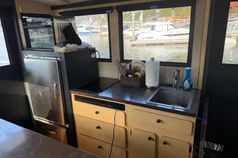 Slide: The Image of Modern kitchen area on a 2020 Armstrong Marine 35 boat with sink and utensils. - 84