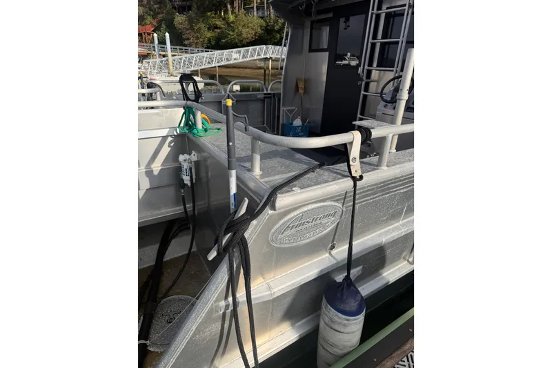 Slide: The Image of Outboard motor on a 2020 Armstrong Marine 35 boat, docked on calm water. - 9