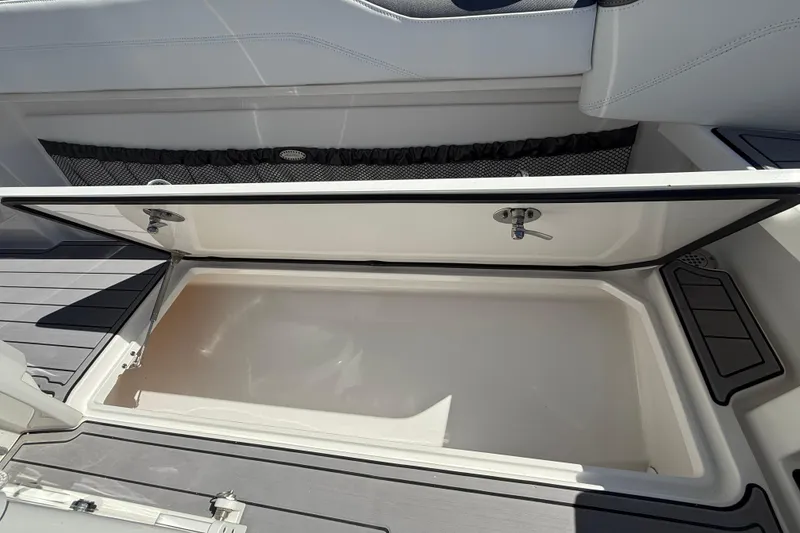 Slide: The Image of 2023 Nor-Tech 340 Sport Open Center Console storage compartment, open and empty. - 12