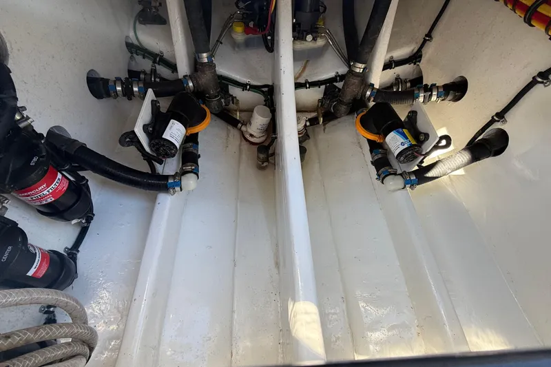 Slide: The Image of 2023 Nor-Tech 340 Sport Open Center Console engine compartment with Mercury components. - 13