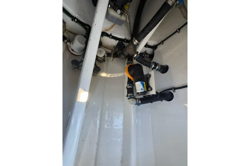 Slide: The Image of 2023 Nor-Tech 340 Sport Open Center Console boat interior plumbing system. - 16