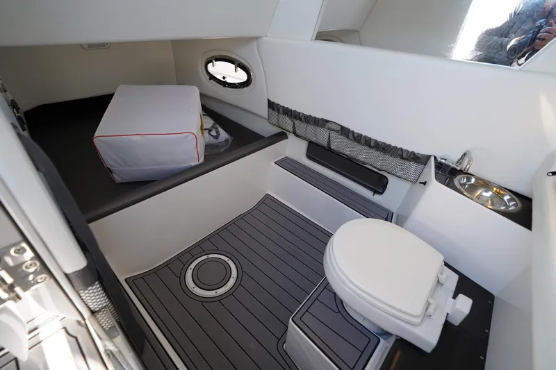Slide: The Image of 2023 Nor-Tech 340 Sport Open Center Console interior with toilet and sink. - 26