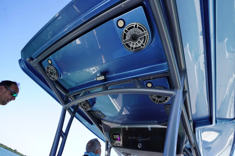Slide: The Image of 2023 Nor-Tech 340 Sport Open Center Console with blue canopy and speakers. - 29