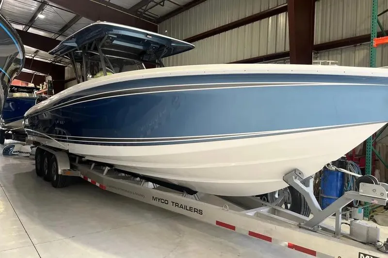 Slide: The Image of 2023 Nor-Tech 340 Sport Open Center Console docked by the water. - 3