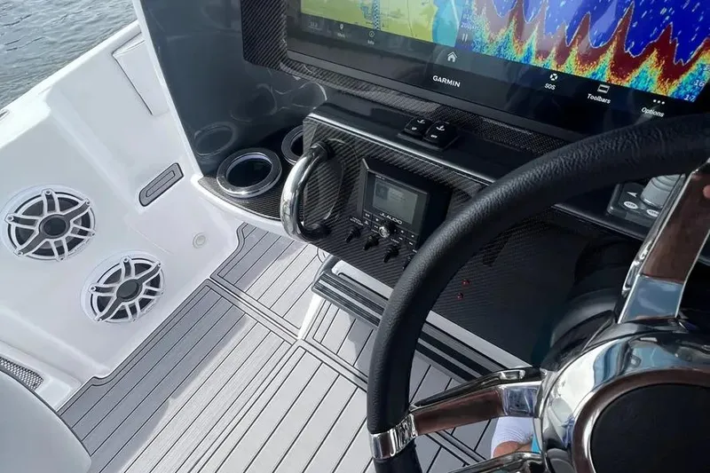 Slide: The Image of 2023 Nor-Tech 340 Sport Open Center Console boat on trailer in storage facility. - 6