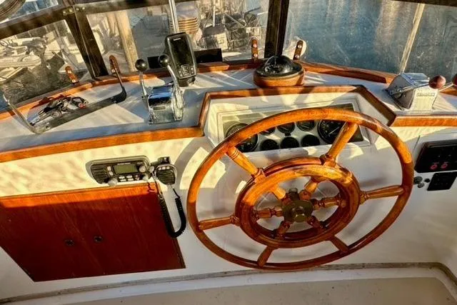 Slide: The Image of 1981 Grand Banks 36 Classic helm with wooden wheel and navigation instruments. - 11