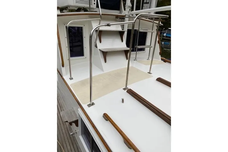 Slide: The Image of 1981 Grand Banks 36 Classic yacht deck with wooden accents and metal railings. - 18