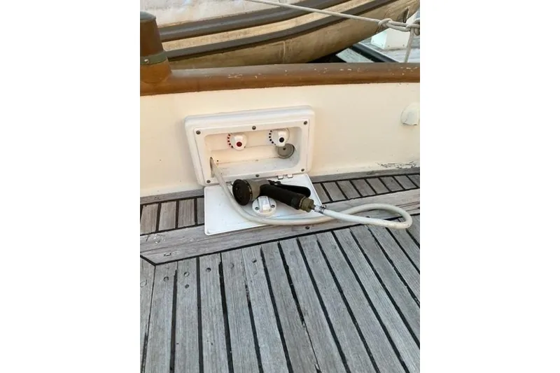 Slide: The Image of 1981 Grand Banks 36 Classic deck with water hose and fittings. - 21