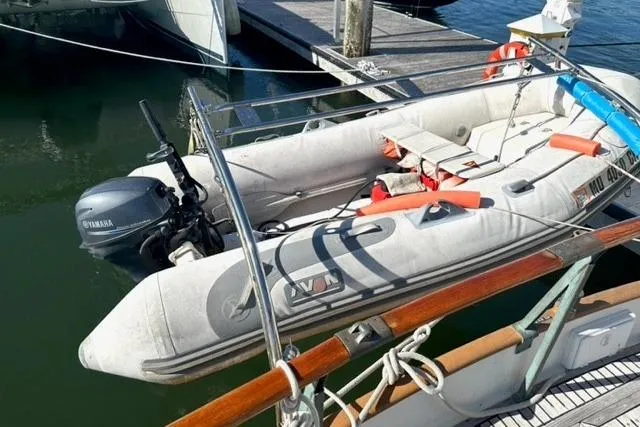 Slide: The Image of Inflatable dinghy with Yamaha motor docked beside 1981 Grand Banks 36 Classic boat. - 23
