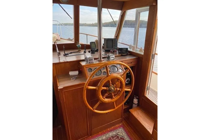 Slide: The Image of 1981 Grand Banks 36 Classic helm with wooden wheel and navigation instruments. - 24