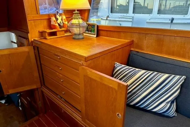 Slide: The Image of Interior of 1981 Grand Banks 36 Classic with wooden cabinetry and striped cushion. - 29