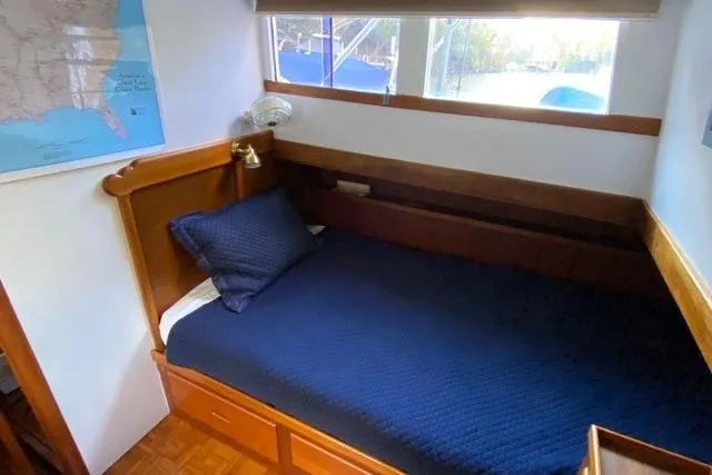 Slide: The Image of Cozy cabin interior of 1981 Grand Banks 36 Classic with blue bedding and wooden accents. - 37
