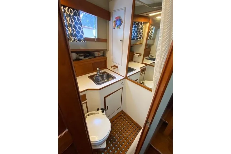 Slide: The Image of 1981 Grand Banks 36 Classic yacht bathroom with sink, toilet, and nautical decor. - 38