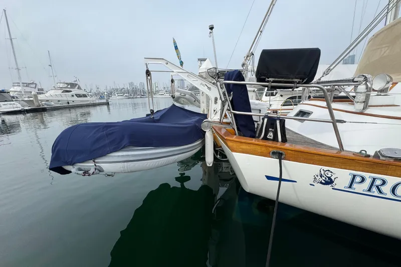 Slide: The Image of 1978 Robert Perry 47 sailboat docked in a marina, showcasing classic design and wooden details. - 11