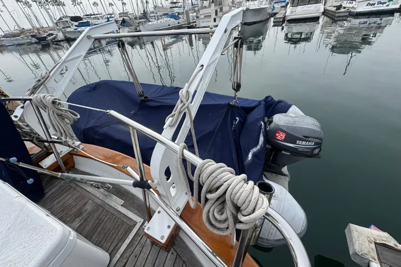 Slide: The Image of 1978 Robert Perry 47 yacht docked with covered dinghy, marina background. - 12
